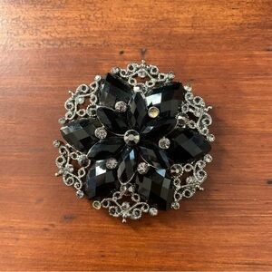 Black rhinestones flower brooch with silver tone filigree